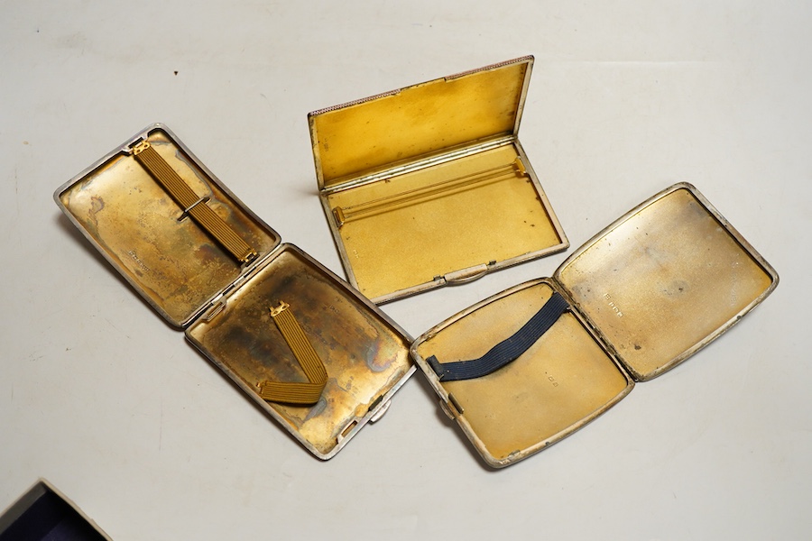 Two George V silver cigarette case, one foliate engraved Birmingham, 1912 the other folaite engraved Birmingham, 1919 Willaim Neale Ltd and a George VI engine turned cigarette case, weight approx. 14.43ozt (3)